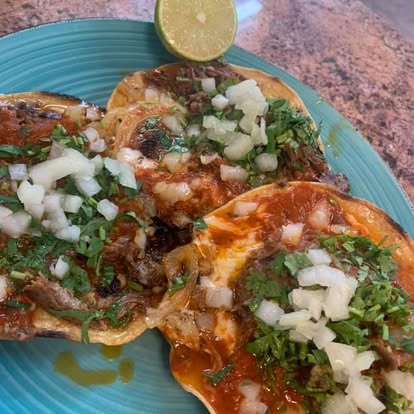 La Revolcada — tortillas bathed in red salsa